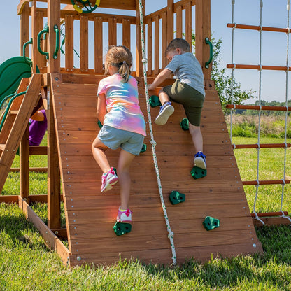 A complete set of wooden mountain-style swings, equipped with a colorful canvas sunshade, a wave slide, a rope swing, a net swing, and a rock wall with climbing ropes and ladders.
